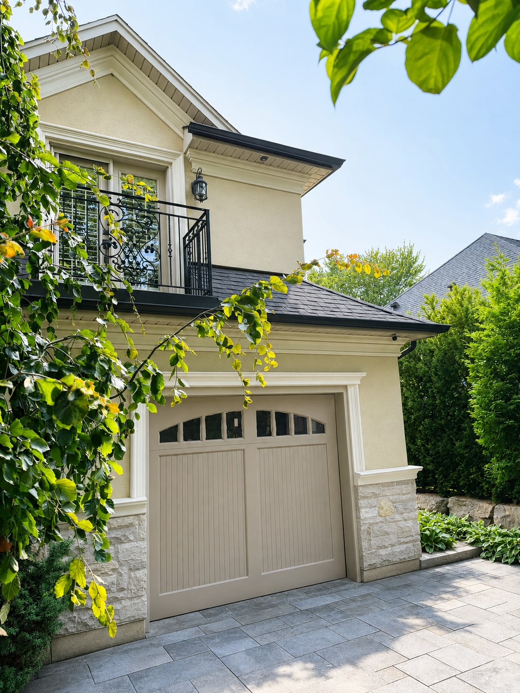 Painted single carriage-style garage door in a landscaped driveway